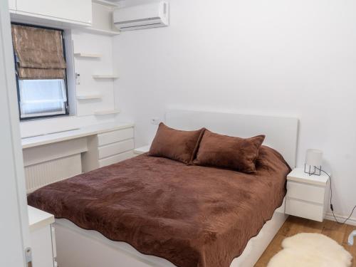 a bedroom with a large bed in a white room at Casa Boes 41 in Vişan