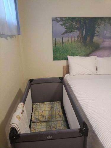 a suitcase sitting next to a bed in a room at Georgia's house in Nikiti