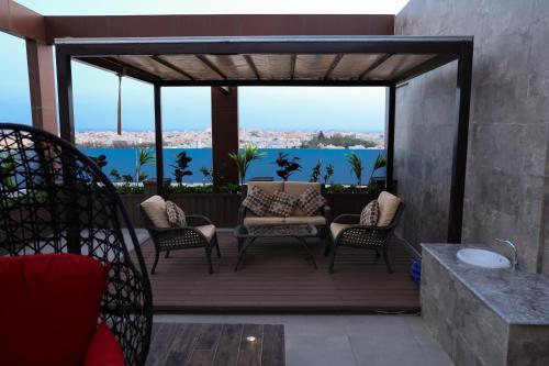 a patio with chairs and a view of the water at شقق الماسة التاج للشقق الفندقية in Hail