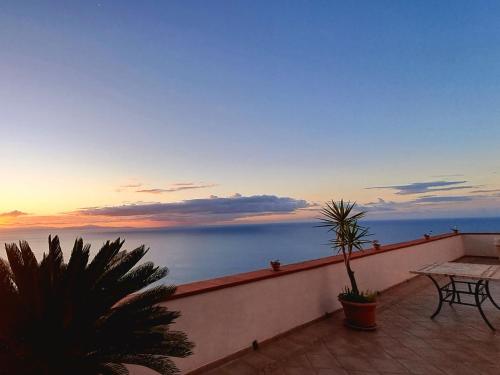 a balcony with a table and a view of the ocean at "CASALENA" Villa a Furore Amalfi coast con grande terrazzo e vista sul MARE in Furore
