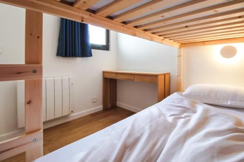 a bedroom with a white bed and a desk at Stunning 4-bedroom apartment Flaine Foret, fully refurbished, beautiful panoramic views in Flaine