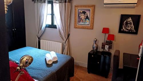 a bedroom with a bed and a window with towels at Dar L'hna in Marrakech