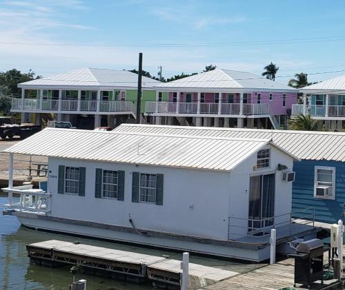 a building on a dock next to a marina at Old Wooden Bridge Resort & Marina in Big Pine Key