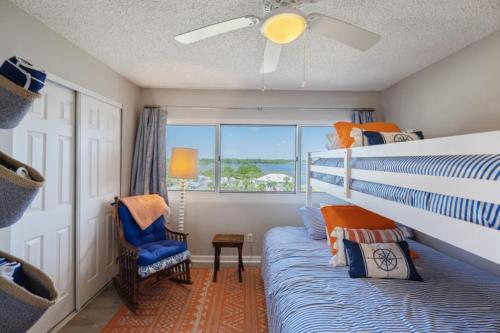 a bedroom with a bed and a chair and a window at Pinnacle Port 304A in Panama City