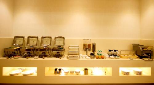a shelf with a bunch of dishes on it at Hotel Le Roi Raipur at Raipur Railway Station in Raipur
