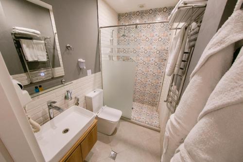 a bathroom with a sink and a toilet and a shower at Zimmer Boutique Hotel in Baku