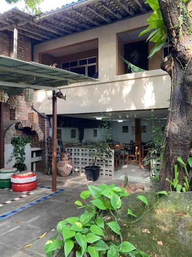 a patio of a house with awning and a table at Hotel Pousada Casuarinas in Recife