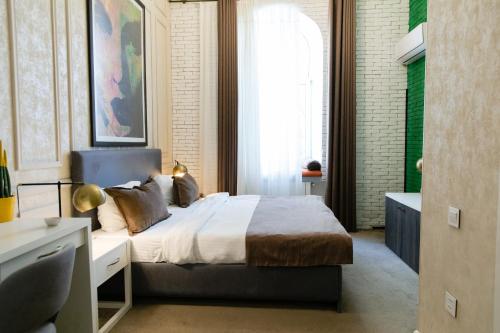 a bedroom with a bed and a large window at Zimmer Boutique Hotel in Baku