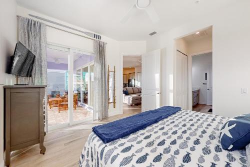 a bedroom with a bed and a view of the ocean at Lavender Life in Saint James City