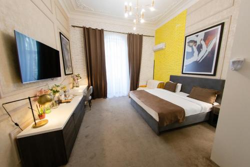 a hotel room with a bed and a television at Zimmer Boutique Hotel in Baku