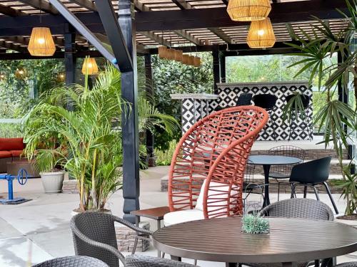 a patio with two chairs and a table and some tables at Hacienda Hosteria Chorlavi in Ibarra