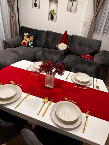 a living room with a table with plates and a red table runner at Ivana&Luka-Put luke 1, Brela in Brela