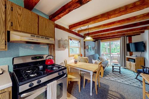 a kitchen and dining room with a stove and a table at Running Fox Farm in Baraboo