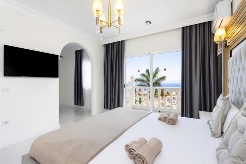 a bedroom with a large bed with a view of the ocean at Villa Exotica in Adeje