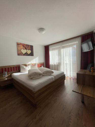a bedroom with a large bed and a window at Gästeheim Lederle in Jerzens