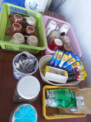 a table with three plastic containers filled with food at Inthavong Hotel/Guest House in Vang Vieng