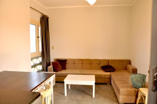 a living room with a couch and a table at Cozy apartments in Coraya Bay