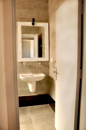 a bathroom with a sink and a mirror at Cozy apartments in Coraya Bay