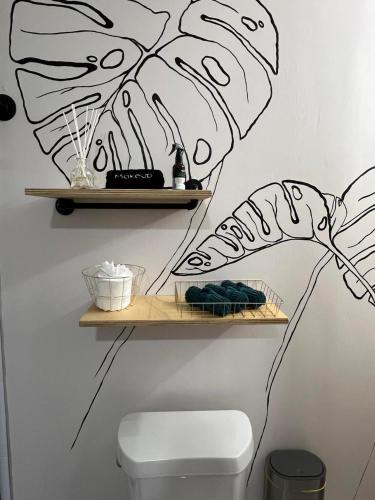 a bathroom with a shelf with a drawing on the wall at Busch Gardens Bliss Suite-2 in Tampa