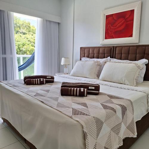 a bedroom with a large bed with two pillows on it at Suíte no Rio Stay Apart-hotel in Rio de Janeiro