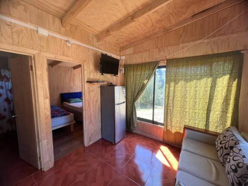 Habitación pequeña con nevera y ventana en Casa de campo en Población Lago Ranco