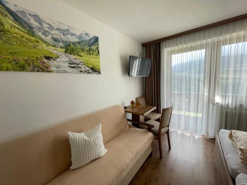 a living room with a couch and a table at Gästeheim Lederle in Jerzens