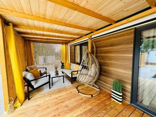 a room with a porch with a swing at Sandra Holiday Homes in Biograd na Moru