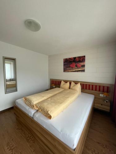 a bedroom with a large bed in a room at Gästeheim Lederle in Jerzens