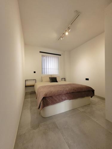 a bedroom with a large bed and a window at El Olive - Calanova Grand golf in Mijas