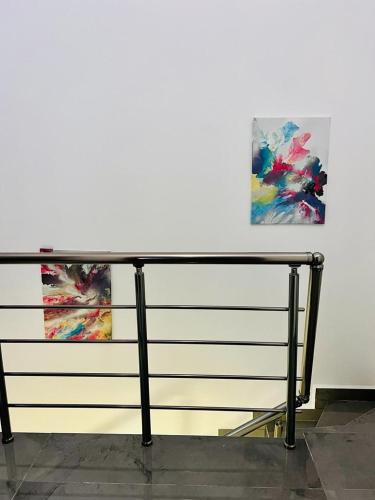 a table in front of two paintings on a wall at AXARA Holiday Home in Xagħra