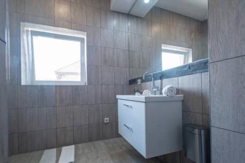 a bathroom with a sink and a mirror at 2022 Central Apartment Maribor (Garden + Parking) in Maribor