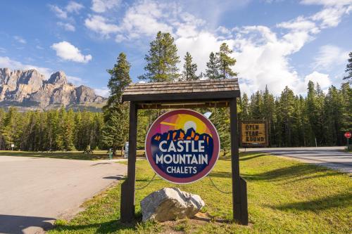 a sign for a castle mountain chasis in a park at Castle Mountain Chalets in Castle Junction