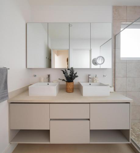 a bathroom with two sinks and a mirror at CASA AYLA A - stunning 5BR Ocean view house & infinity pool in Flamingo in Playa Flamingo