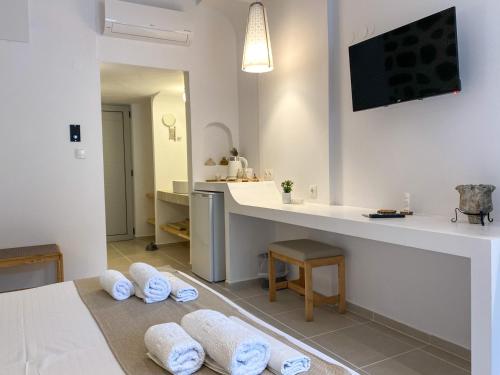 a bathroom with a counter and towels on the floor at Ladiko Inn Hotel Faliraki -Anthony Quinn Bay in Faliraki