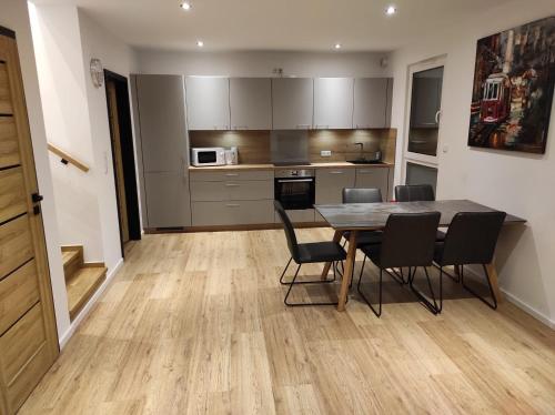 a kitchen and dining room with a table and chairs at Seepark 13 in Goch
