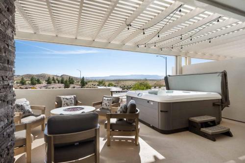 a patio with a hot tub and a table and chairs at Sunsets and Sandcastles townhouse in St. George
