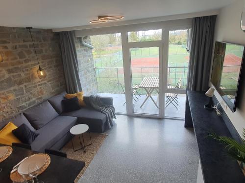 a living room with a couch and a table at À Durbuy in Durbuy