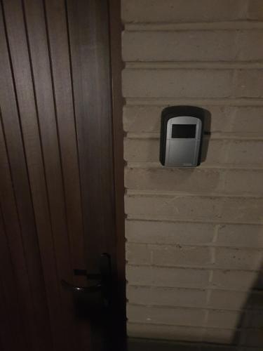 a television on the side of a brick wall at À Durbuy in Durbuy