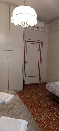 a room with two beds and a large chandelier at Affittacamere Pratello 97 in Bologna