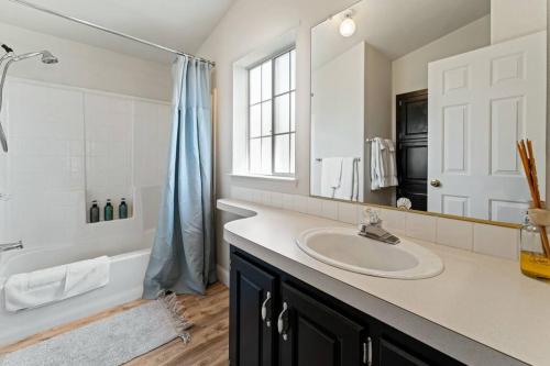 a bathroom with a sink and a tub and a mirror at Stunning North Fork Cabin w/ Free Wi-Fi & Smart TV in North Fork