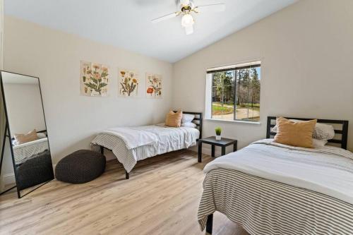 a bedroom with two beds and a window at Stunning North Fork Cabin w/ Free Wi-Fi & Smart TV in North Fork