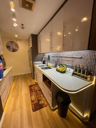 a kitchen with a sink and a counter top at Elegant 2BR, 2 BA Suite Beside Eastwood Mall in Manila