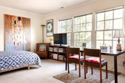 a bedroom with a bed and a desk with chairs at Free Parking on a Private St., Minutes to Georgetown, MedStar Hospital, Georgetown University and more in Washington