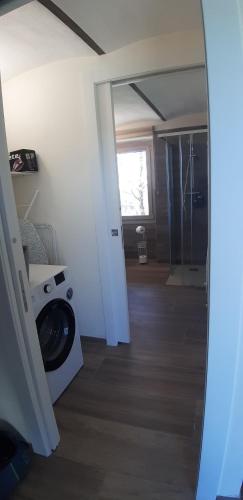 a bathroom with a washing machine in a room at CASCINA BINELLO appartamento B in Murazzano