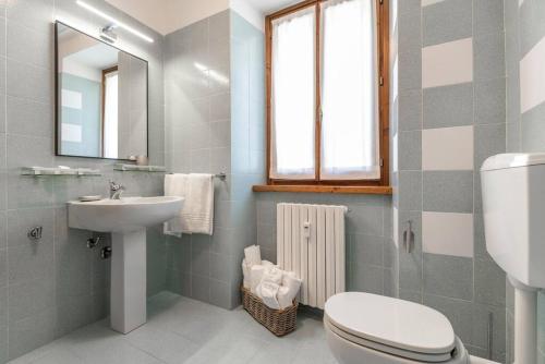 a bathroom with a toilet and a sink at Intero appartamento in Carona