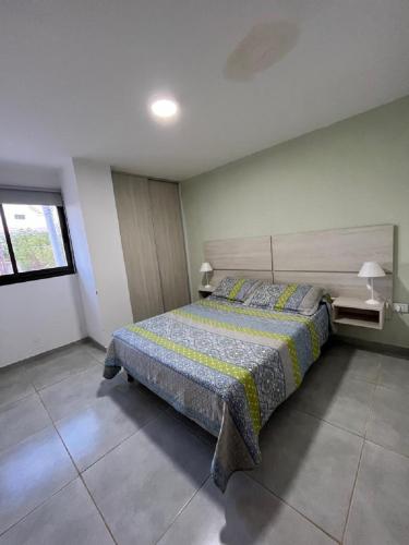 Schlafzimmer mit einem Bett und einem Fenster in der Unterkunft Complejo 9 De Julio in Villa Dolores