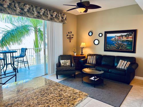 a living room with a couch and a table at Boca Ciega Resort in St. Petersburg