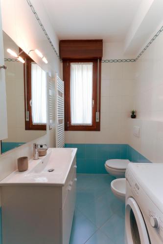 a bathroom with a white sink and a toilet at Anna in Cavallino-Treporti