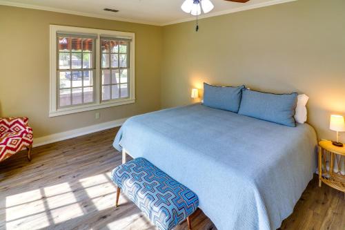 a bedroom with a blue bed and a window at Centrally Located Abilene Abode 2 Mi to Downtown! in Abilene