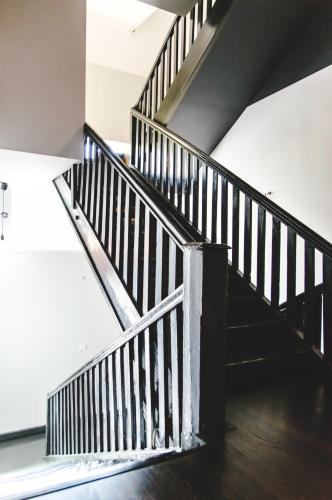 a wooden staircase in a room with a ceiling at The House in Druskininkai